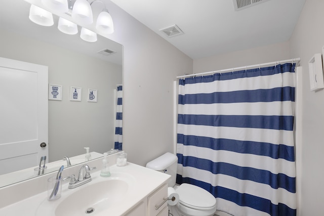 full bathroom with vanity, toilet, and visible vents