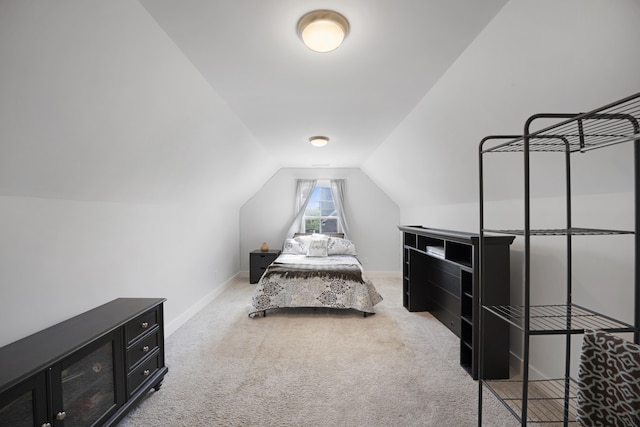 carpeted bedroom with baseboards and lofted ceiling
