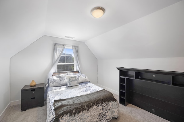 carpeted bedroom featuring visible vents, baseboards, and lofted ceiling