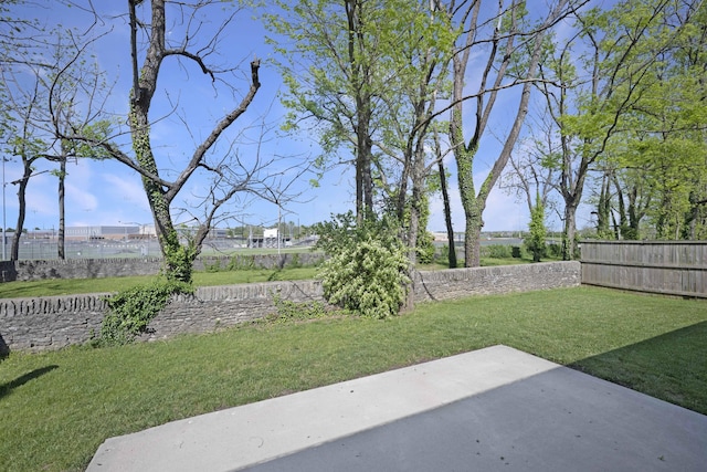 view of yard featuring fence and a patio