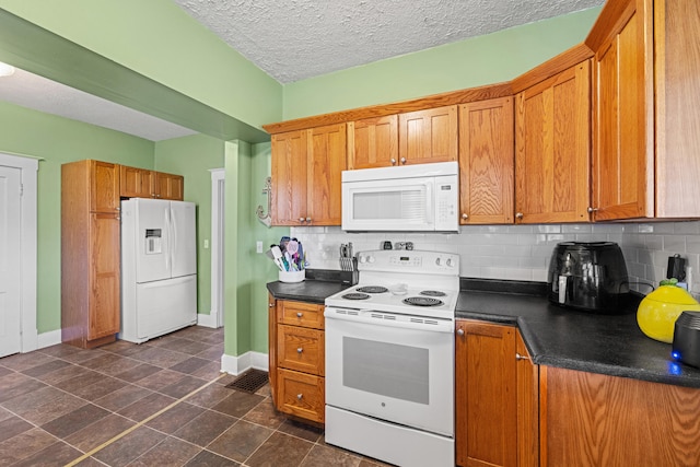 123 Baughman Ave, Danville, KY 40422 - kitchen with dark countertops, white appliances, brown cabinetry, baseboards, and backsplash