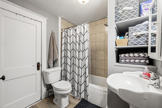 123 Baughman Ave, Danville, KY 40422 - full bath featuring a textured ceiling, wood finished floors, a sink, toilet, and shower / bath combo with shower curtain