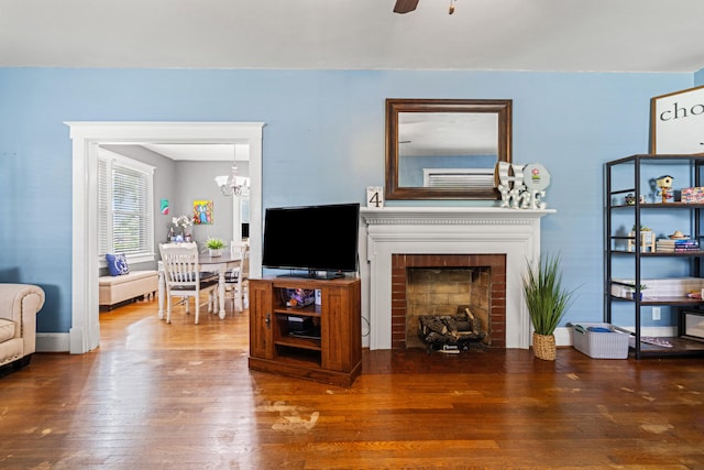 123 Baughman Ave, Danville, KY 40422 - living room with ceiling fan with notable chandelier, wood finished floors, and a fireplace
