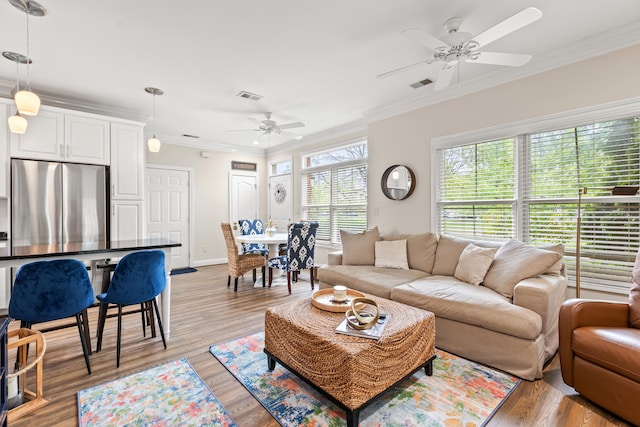 963 Star Shoot Pkwy, Lexington, KY 40509 - living room featuring crown molding, visible vents, baseboards, a ceiling fan, and light wood-style flooring