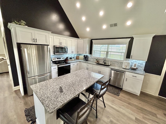 11 Marco Island Dr, Somerset, KY 42503 - kitchen featuring appliances with stainless steel finishes, a sink, white cabinetry, high vaulted ceiling, and recessed lighting