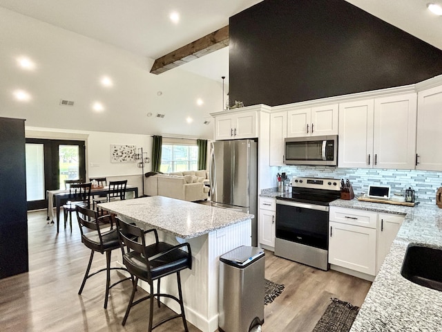 11 Marco Island Dr, Somerset, KY 42503 - kitchen with stainless steel appliances, beam ceiling, backsplash, a center island, and white cabinets