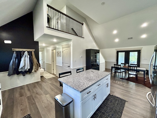 11 Marco Island Dr, Somerset, KY 42503 - kitchen with high vaulted ceiling, french doors, light stone counters, wood finished floors, and freestanding refrigerator