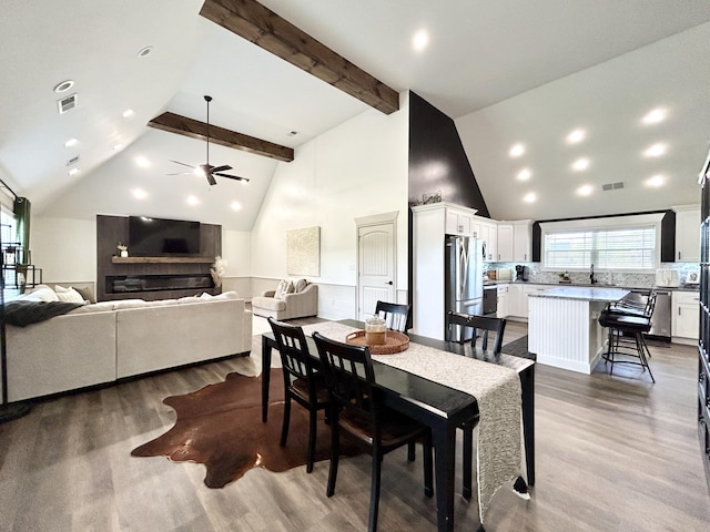 11 Marco Island Dr, Somerset, KY 42503 - dining room featuring wood finished floors, a ceiling fan, high vaulted ceiling, and beamed ceiling