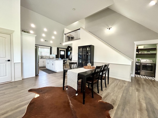 11 Marco Island Dr, Somerset, KY 42503 - dining room featuring washer / dryer, wood finished floors, high vaulted ceiling, and built in features