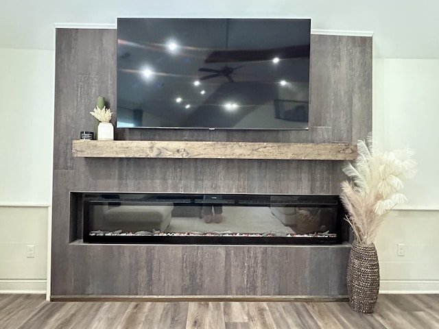 11 Marco Island Dr, Somerset, KY 42503 - detailed view of a glass covered fireplace, wood finished floors, baseboards, and ceiling fan