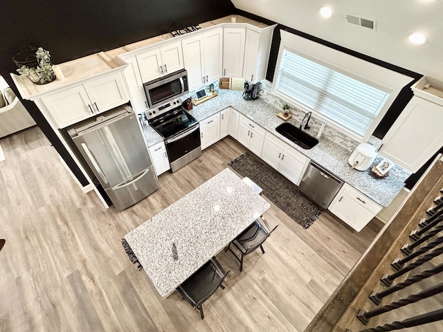 11 Marco Island Dr, Somerset, KY 42503 - kitchen with a sink, stainless steel appliances, light wood finished floors, white cabinets, and backsplash