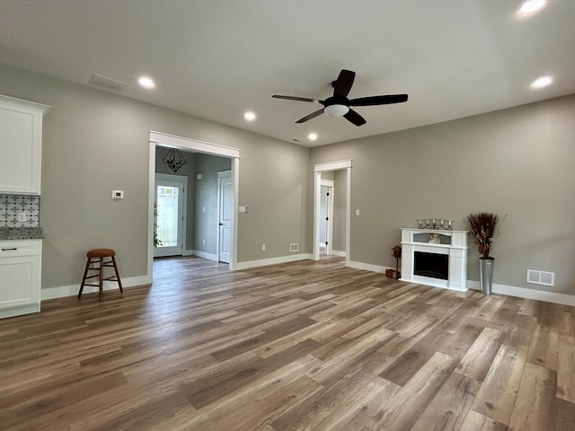 108 Patriot Dr, Science Hill, KY 42553 - unfurnished living room with wood finished floors, ceiling fan, recessed lighting, a fireplace, and baseboards