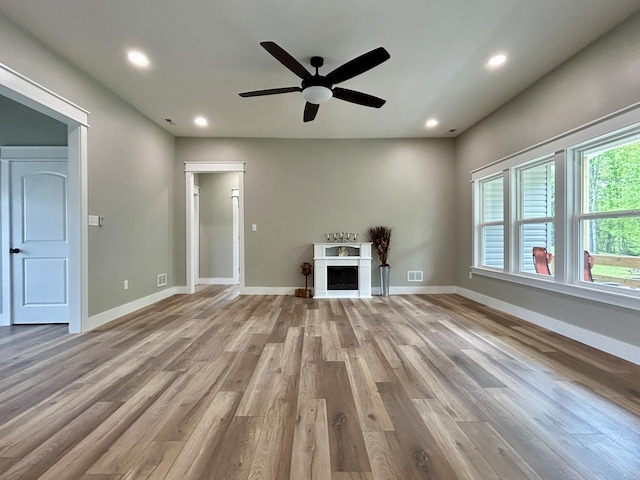 108 Patriot Dr, Science Hill, KY 42553 - unfurnished living room with ceiling fan, wood finished floors, recessed lighting, a fireplace, and baseboards