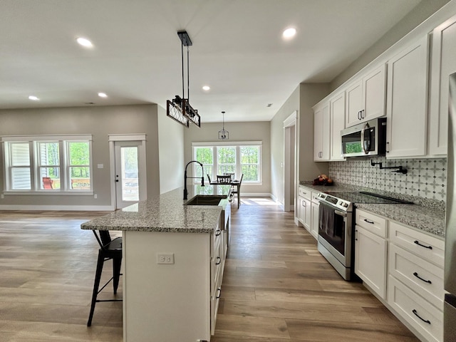 108 Patriot Dr, Science Hill, KY 42553 - kitchen featuring appliances with stainless steel finishes, a sink, baseboards, recessed lighting, and white cabinets