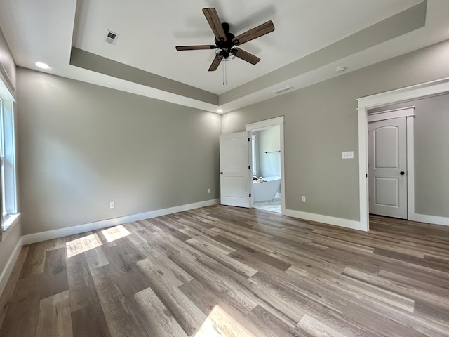 108 Patriot Dr, Science Hill, KY 42553 - unfurnished bedroom with a tray ceiling, wood finished floors, baseboards, and recessed lighting