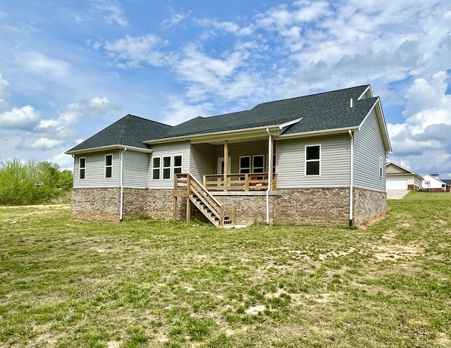 108 Patriot Dr, Science Hill, KY 42553 - rear view of house featuring a yard, brick siding, roof with shingles, and stairway