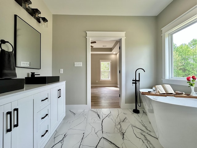 108 Patriot Dr, Science Hill, KY 42553 - bathroom featuring a freestanding bath, baseboards, vanity, and marble finish floors