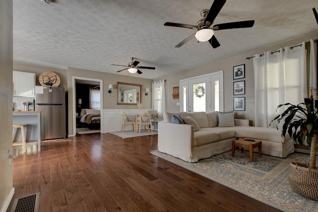 51 Ivy Ln, Wellington, KY 40387 - living room featuring wainscoting, a textured ceiling, a ceiling fan, visible vents, and dark wood-style floors