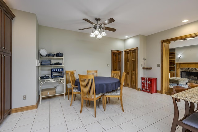 dining area featuring recessed lighting, ceiling fan, light tile patterned flooring, and a fireplace