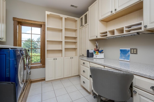 office area featuring washing machine and dryer, light tile patterned flooring, built in desk, and visible vents