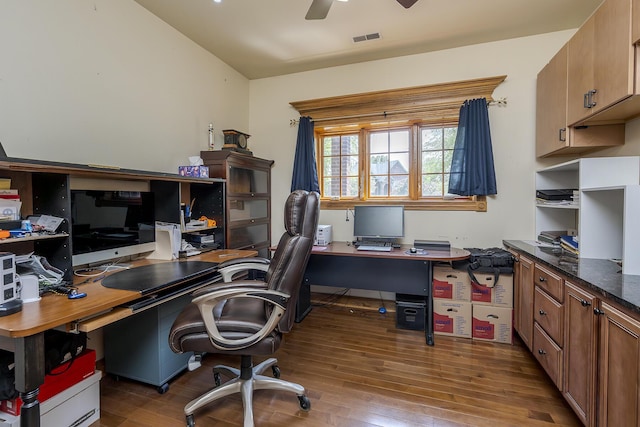 office featuring a ceiling fan, visible vents, and wood finished floors