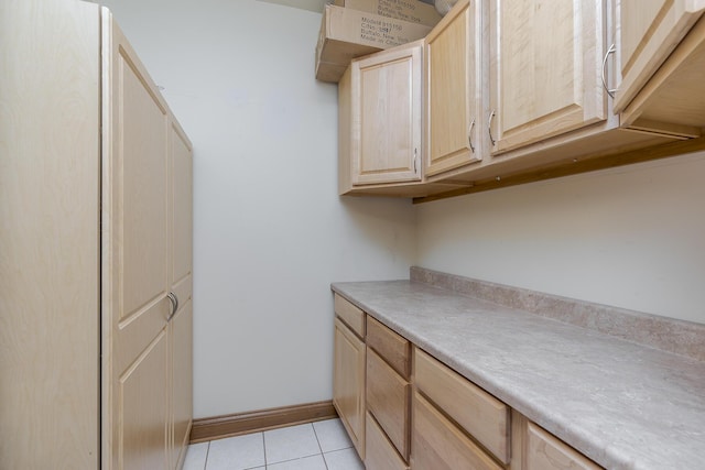 washroom featuring baseboards and light tile patterned floors