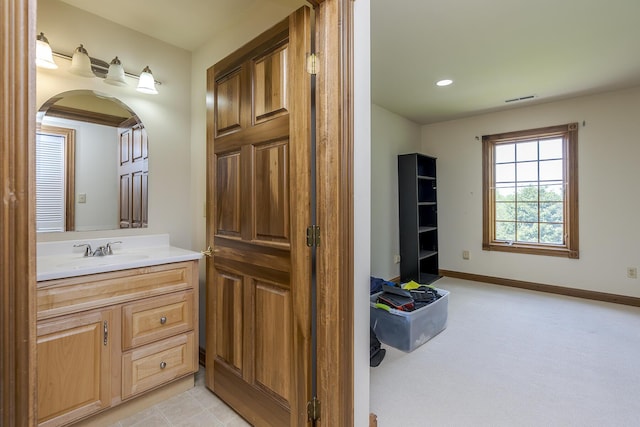 bathroom featuring vanity, recessed lighting, baseboards, and visible vents
