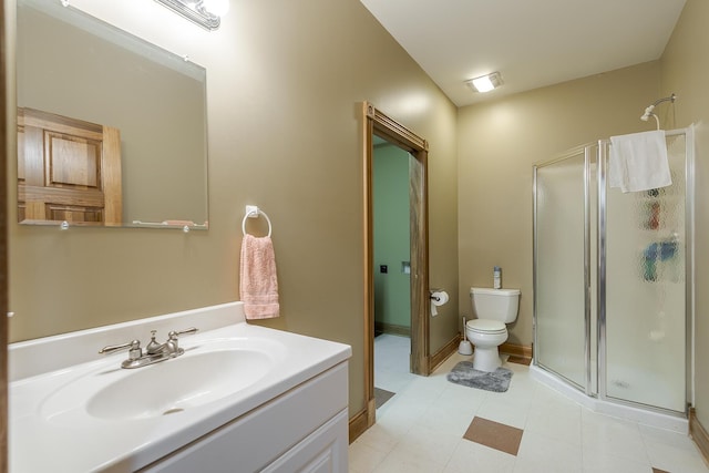 bathroom featuring vanity, a shower stall, and toilet