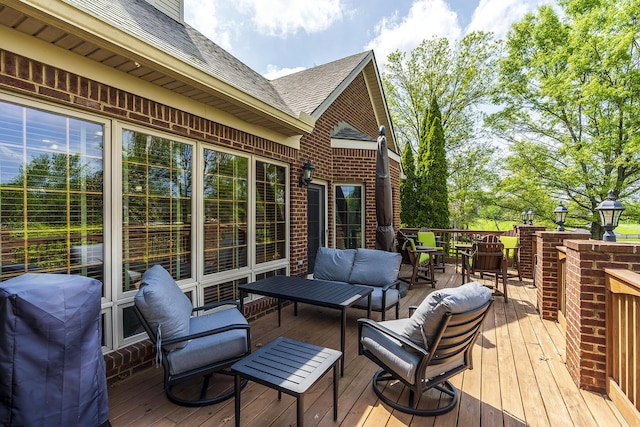 deck featuring area for grilling and an outdoor living space