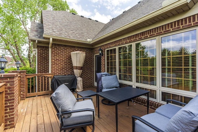 wooden terrace with outdoor lounge area and a grill