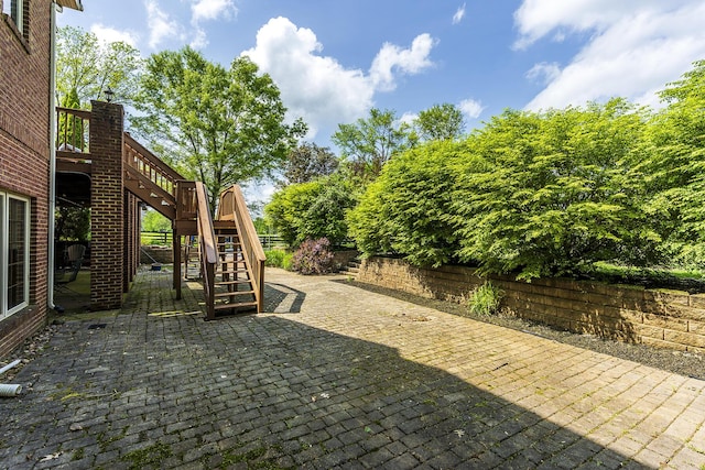 view of patio featuring stairs and a wooden deck