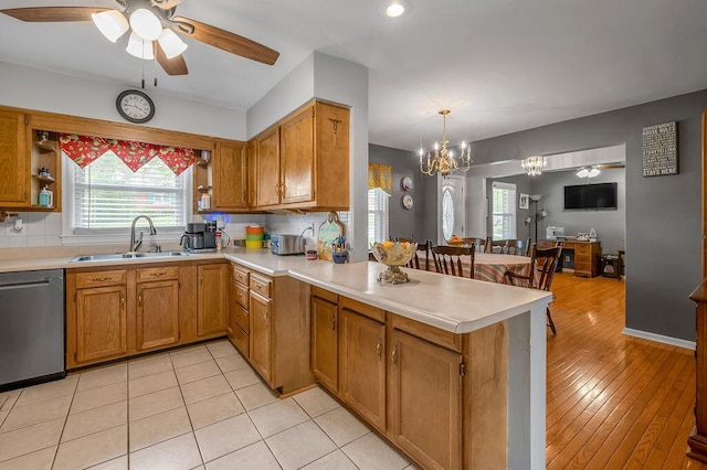 525 Hiawatha Trl, Frankfort, KY 40601 - kitchen with a sink, stainless steel dishwasher, a peninsula, light countertops, and brown cabinetry
