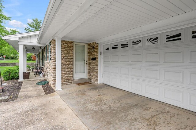 525 Hiawatha Trl, Frankfort, KY 40601 - view of exterior entry featuring stone siding, concrete driveway, a garage, and a porch