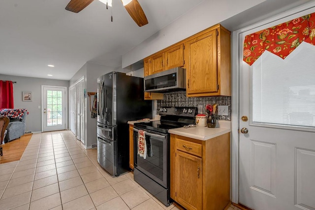 525 Hiawatha Trl, Frankfort, KY 40601 - kitchen with electric stove, stainless steel microwave, freestanding refrigerator, tasteful backsplash, and light tile patterned floors
