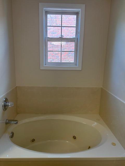 bathroom with a tub with jets