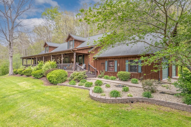 log home with a front yard, a porch, board and batten siding, and roof with shingles