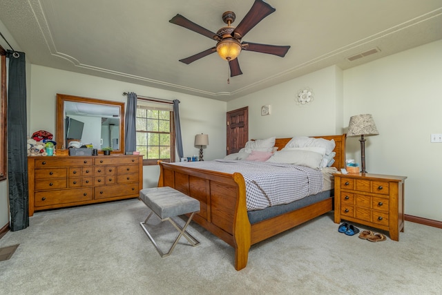 carpeted bedroom featuring baseboards and a ceiling fan
