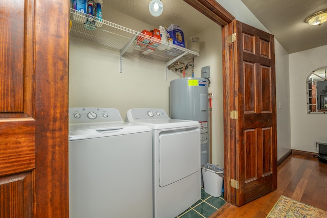 washroom with separate washer and dryer, hardwood / wood-style flooring, and water heater