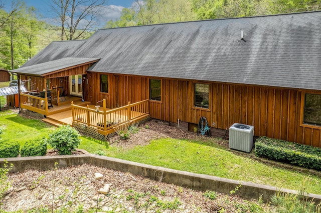 rear view of house featuring central air condition unit, a wooden deck, board and batten siding, and a shingled roof
