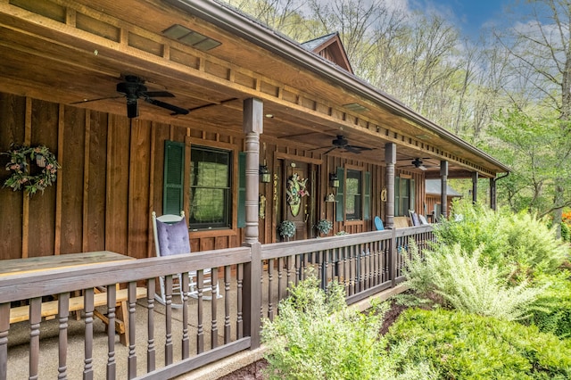 view of side of home with a ceiling fan, a porch, and board and batten siding