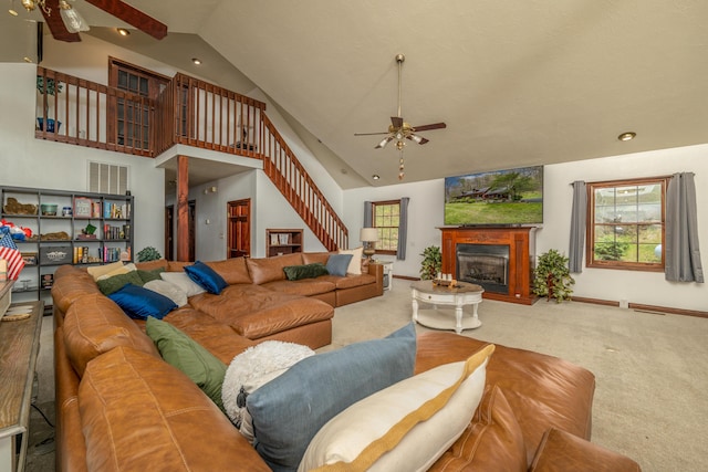 living area with ceiling fan, high vaulted ceiling, carpet, plenty of natural light, and stairway