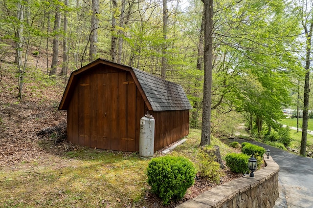 view of shed featuring a wooded view