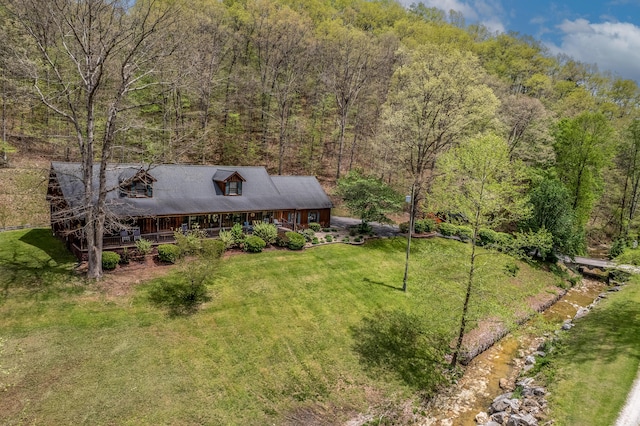 view of subject property featuring a heavily wooded area
