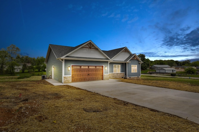craftsman-style home with concrete driveway, an attached garage, and board and batten siding
