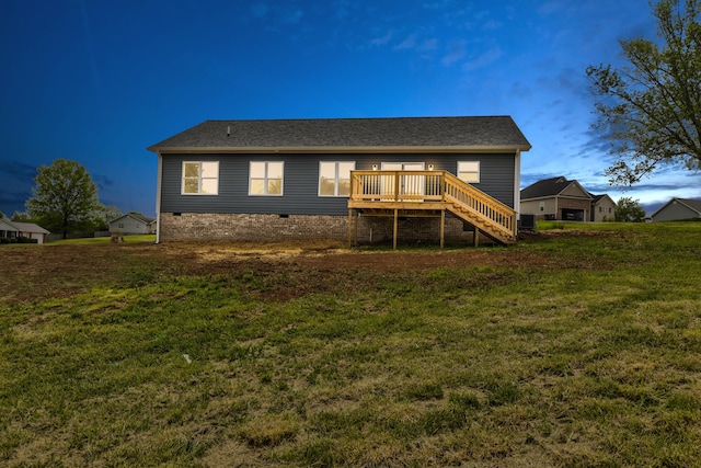 back of property featuring a lawn, stairs, a deck, and crawl space