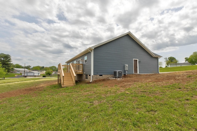 view of side of home featuring crawl space, a wooden deck, central AC, a yard, and stairs