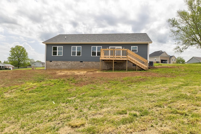 rear view of house featuring a lawn, stairs, a deck, and crawl space
