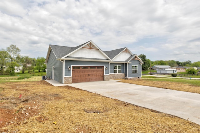 craftsman-style house with a garage, board and batten siding, driveway, and a front yard