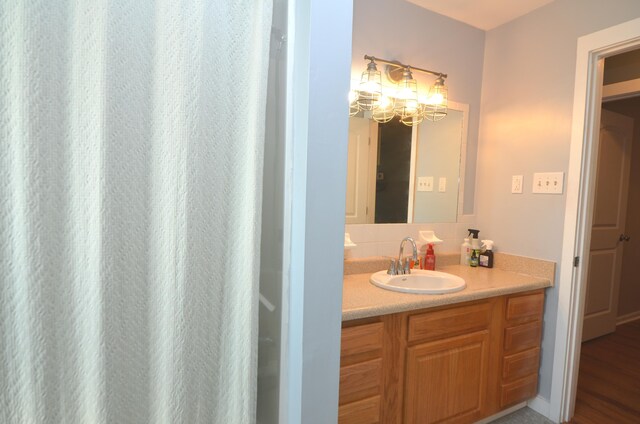 bathroom with an inviting chandelier and vanity
