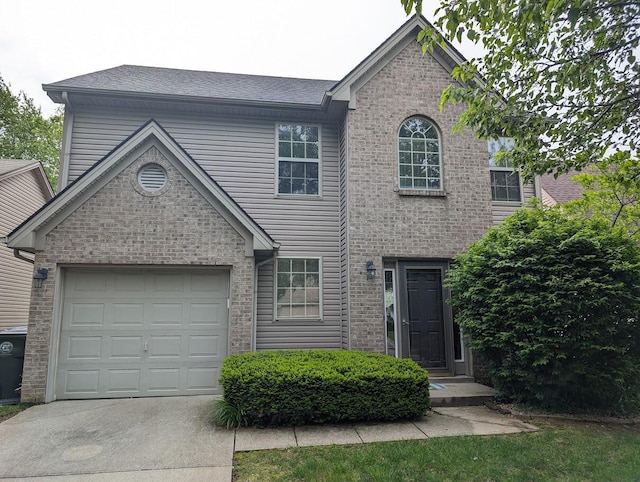 traditional-style home featuring a garage, a shingled roof, concrete driveway, and brick siding